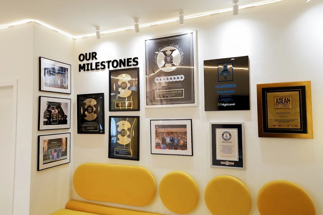 Awards and milestone photographs above yellow seating at GenAI HQ
