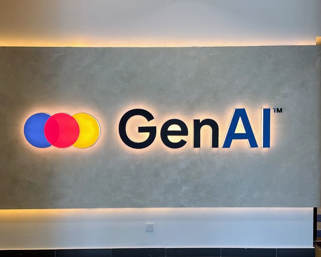 The illuminated GenAI name and three-circle logo on the HQ wall